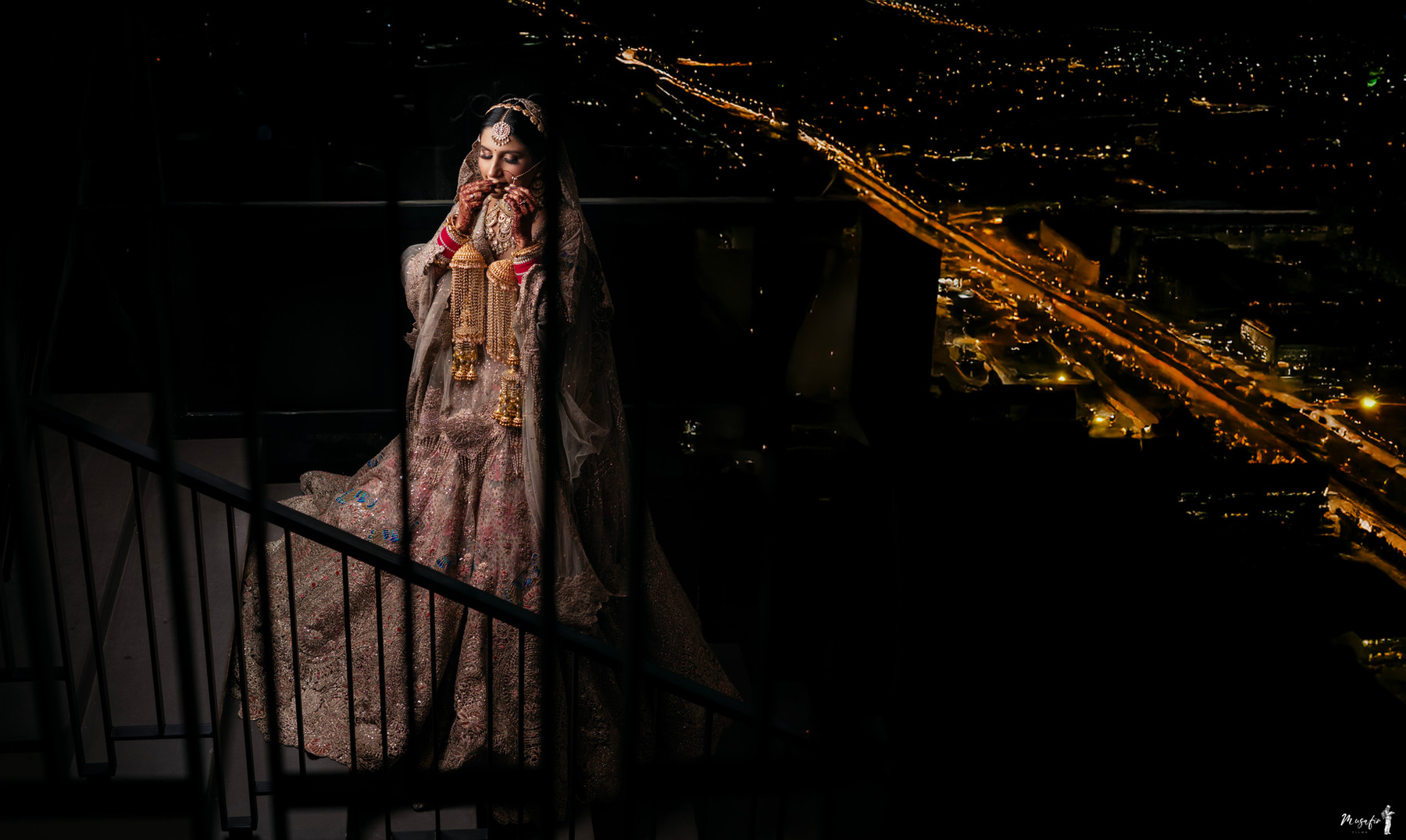 A bridal portrait with city lights beyond