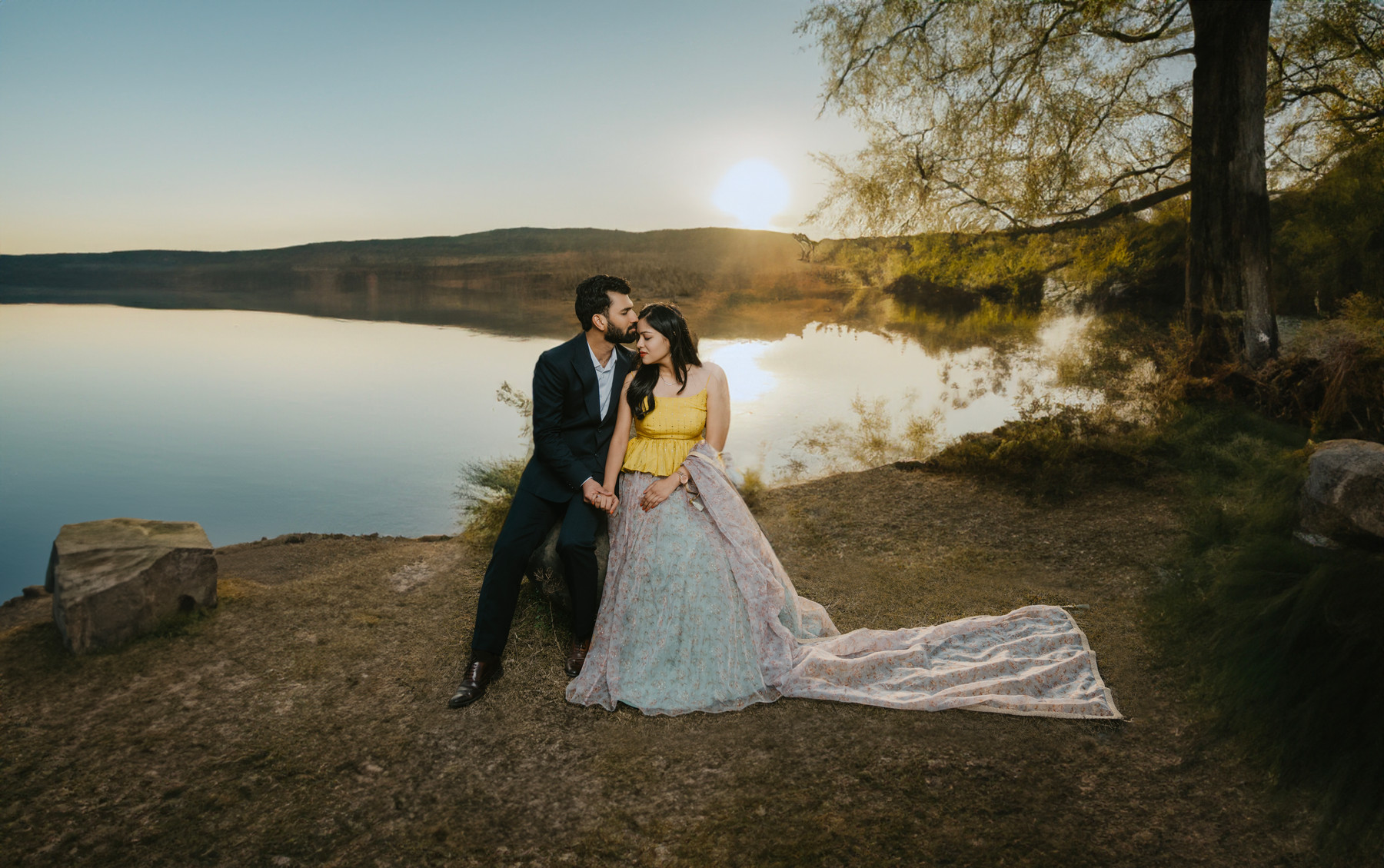 A couple beside the water in the evening light