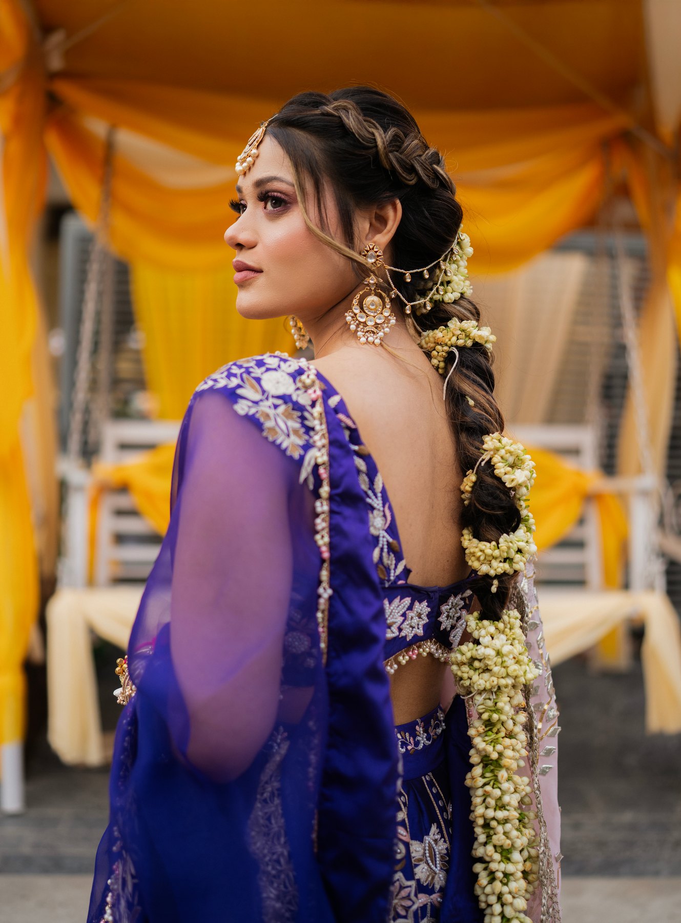 A bridal portrait in purple with floral hair details