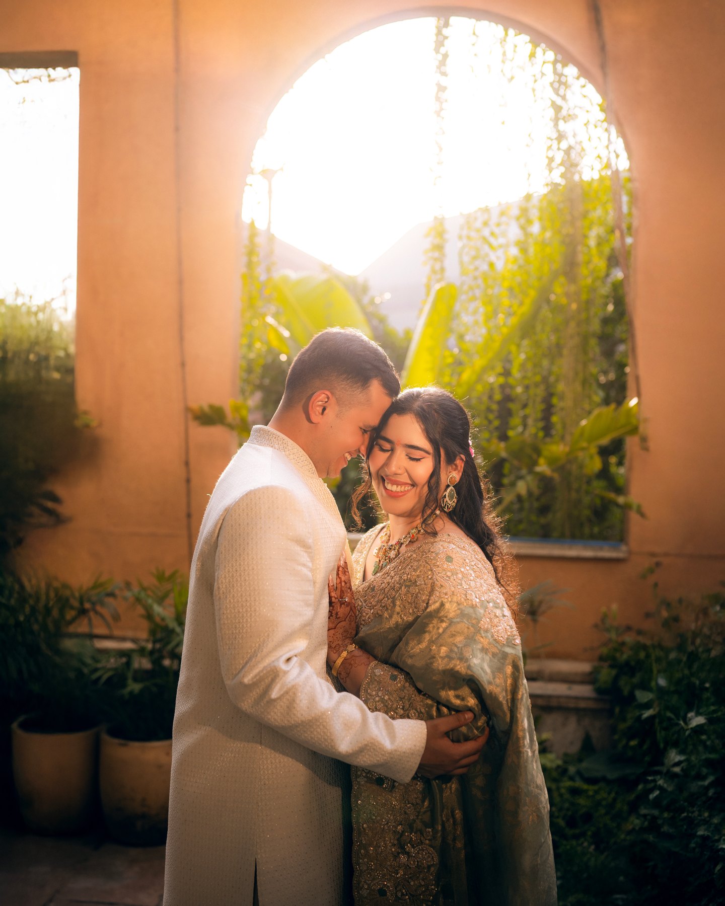 A couple sharing a quiet embrace in golden window light