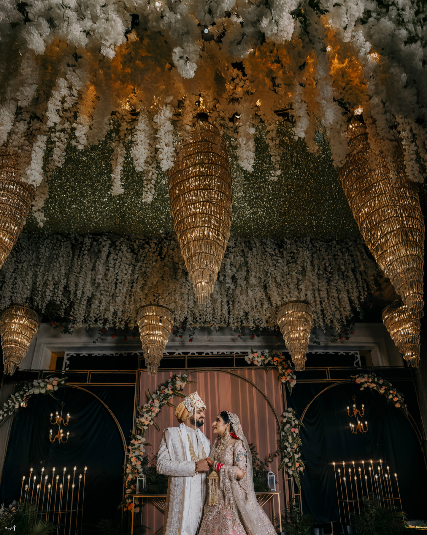 A wedding celebration beneath chandeliers