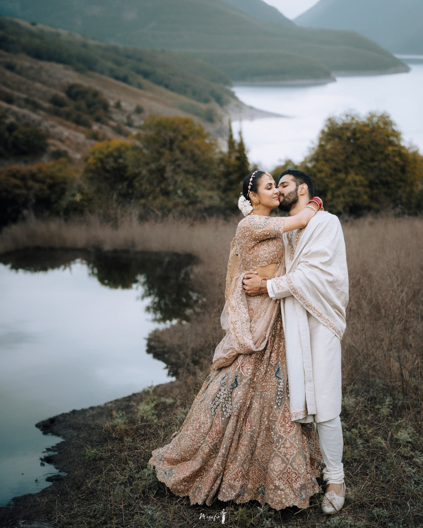 Wedding couple beside a mountain lake